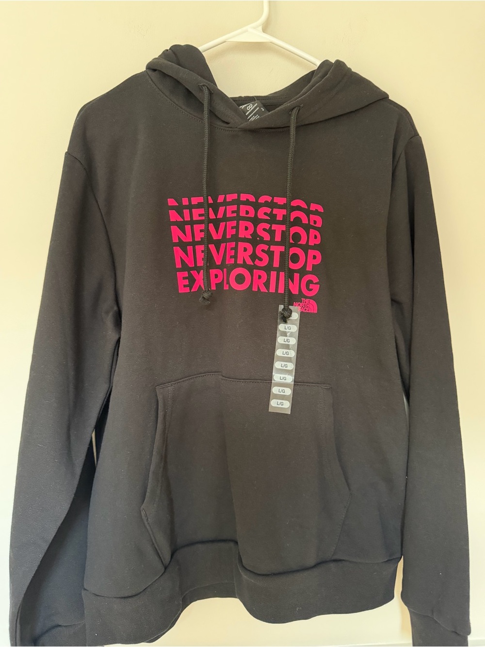 The North Face Black Hoodie with Pink "Never Stop Exploring" Print